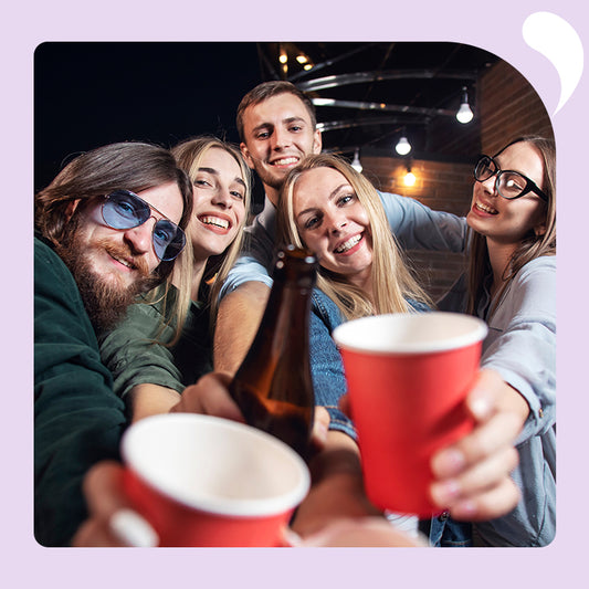 5 young people raise their glasses to the camera