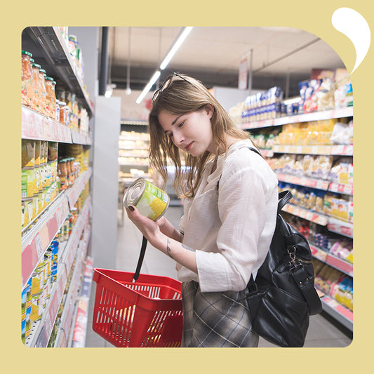 a woman is selecting canned foods