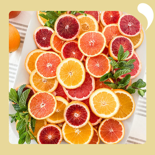 sliced oranges and grapefruit piled up together