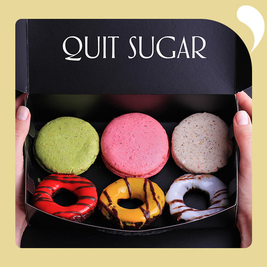 a box of macarons and doughnuts, the box says quit sugar