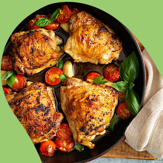 cooked boneless chicken thighs and tomatoes in a pot