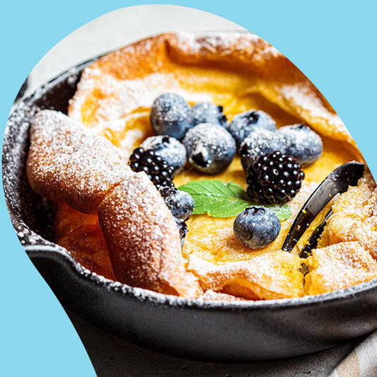 german pancake with blueberries and blackberries on top
