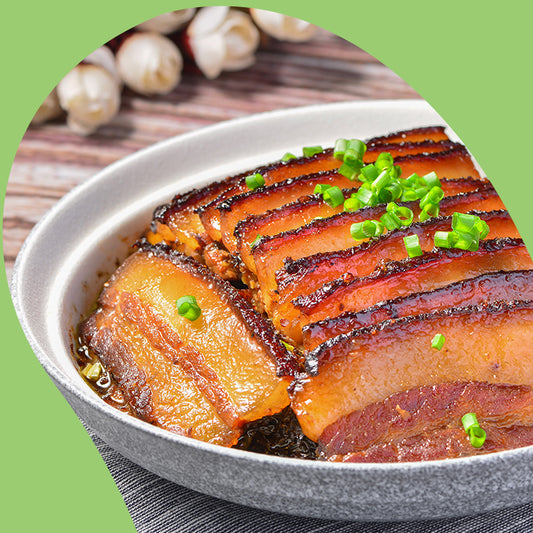 pork belly bites and chopped spring onions on plate with chopsticks
