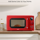 Red microwave with retro design, placed in kitchen setting.