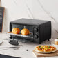 black comfee toaster oven behind a plate of food and cutlery