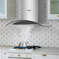 wall mount ducted range hood sucking smoke from a kettle on a oven